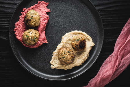 An overhead shot of meatballs with spices on the black plateの写真素材