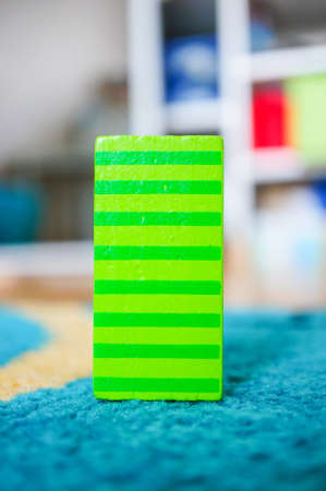 A rectangular striped toy for children put on a multicolored surfaceの写真素材