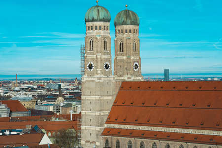 The Frauenkirche surrounded by buildings under the sunlight and a blue sky in Germanyの写真素材