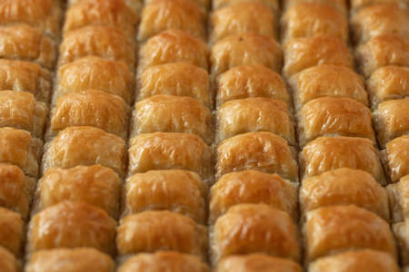 A closeup of baklava cut in cubes under the lights with a blurry backgroundの写真素材