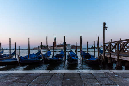 A high angle shot of gondolas parked in the canal in Venice, Italyの写真素材