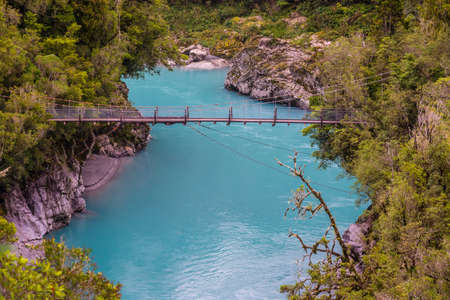 A high angle shot of a wooden bridge over a lakeの写真素材