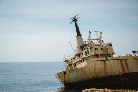 A ship on the water next to the stones of the shore during daytimeの写真素材