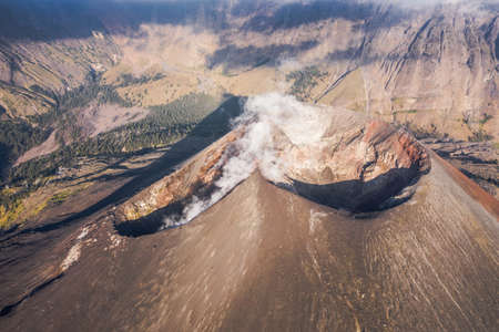 A closeup shot of a mountain range and with smoke coming out of a mountainの写真素材