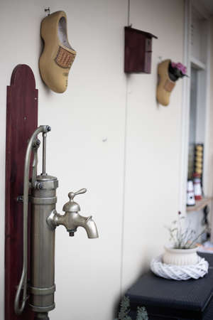 A vertical closeup shot of an antique sink in a room