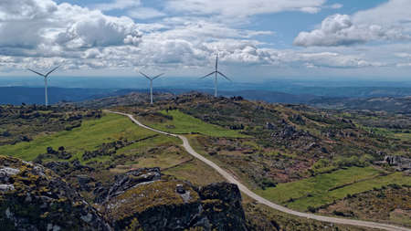 A wide angle shot of white wind fans on a large grassland