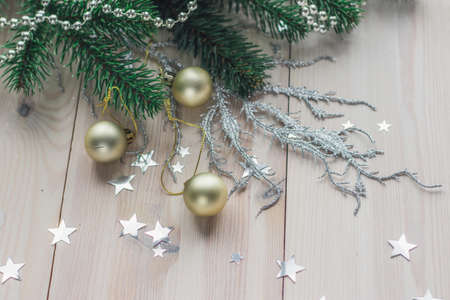 A high angle view of colorful Christmas decorations on the wooden table under the lightsの写真素材