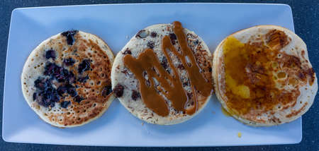A closeup shot of pancakes with different toppings in Aruba