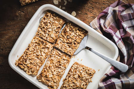 A top view shots of sliced cake with nuts in a plate