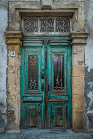 A vertical shot the turquoise doors of an old buildingの写真素材