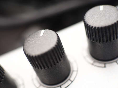 A closeup shot of black buttons on an instrumentの写真素材