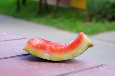a closeup shot of a watermelon rind on a wooden tableの写真素材