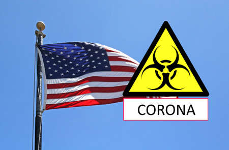 The United States flag and a coronavirus road sign information message