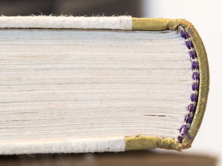 closeup of a dirty  worn hardcover book in soft focusの写真素材