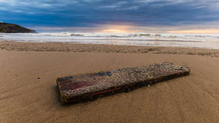 A beautiful shot of a wooden boat on a beach shoreの写真素材