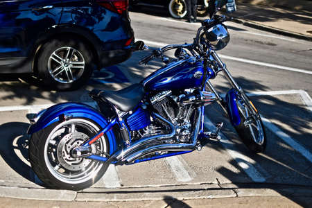 DOWNERS GROVE, UNITED STATES - Jun 07, 2019: A blue shiny chopper motorcycle in the parking lotの写真素材
