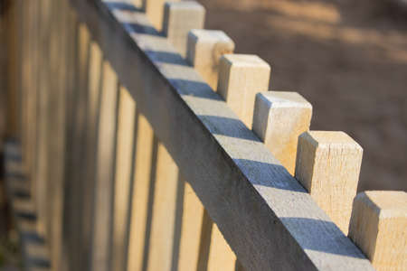 A closeup shot of the top of a balk  timber fence in a farmの写真素材