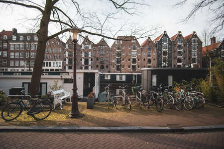 A wide shot of old apartment buildings with bikes parked on the sidewalkの写真素材