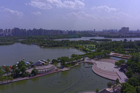 A wide angle shot of water surrounded trees in a park