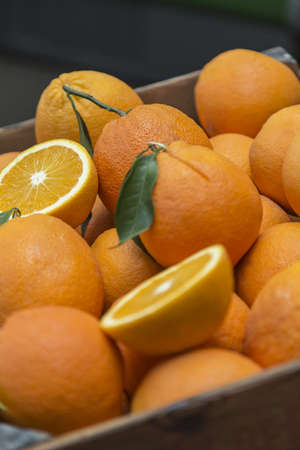 a vertical shot of a crate full of fresh orange fruits