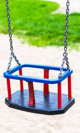 A  closeup shot of a toddler's swing with blrurry backgroundの写真素材