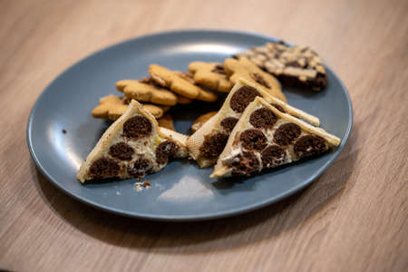 A closeup shot of different pastries on a blue plate on a wooden table