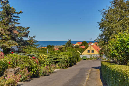 A street leading down towards Baltic sea in Svaneke, Bornholm island, Denmarkの写真素材