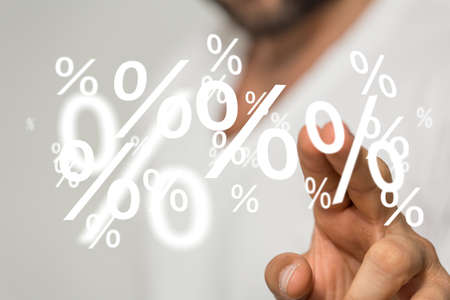An illustration of several percentage signs over a person's fingersの写真素材