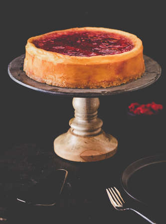 A beautiful shot of the cake on the stand with a black backgroundの写真素材