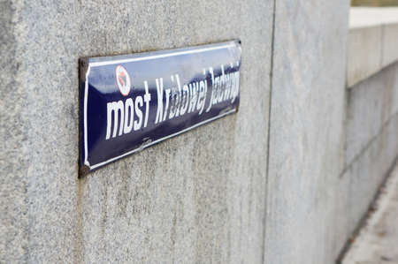 POZNAN, POLAND - Sep 24, 2013: Name sign on a wall of a stone bridge.