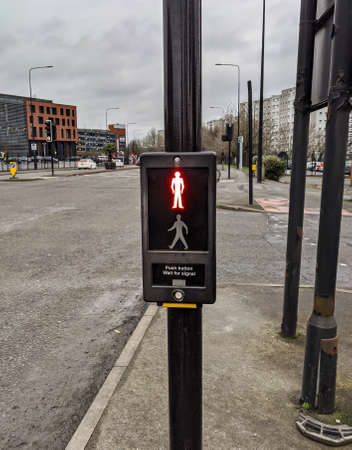 A vertical shot of a puffin crossing signal light in the roadの写真素材
