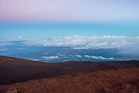 Sandy hills with a blue bright sky and white cloudsの写真素材