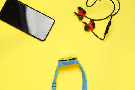 An aerial shot of modern gadgets with a yellow surface backgroundの写真素材