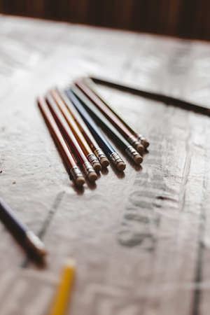 A vertical closeup shot of colorful drawing pencils on a blurry surfaceの写真素材