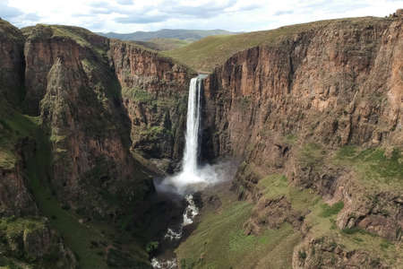 stunning waterfall running down a steap canyon at Semonkong village and it's waterfall and Morija...