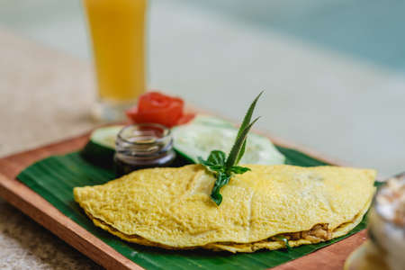 A tray of food next to a glass of juice on a tableの写真素材