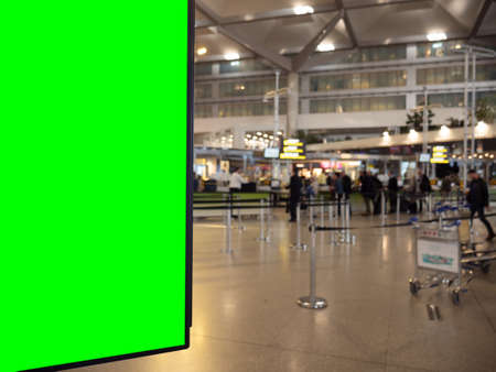 A display board with a green space for your image in an airport