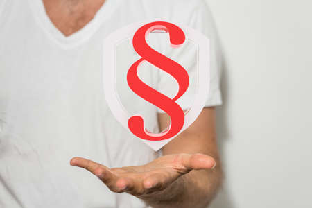 An illustration of a paragraph sign over a person's  hand