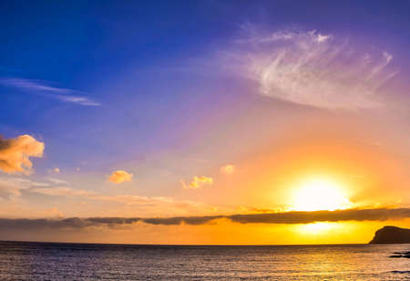 A beautiful scenery of the sunset reflecting on the seaの写真素材