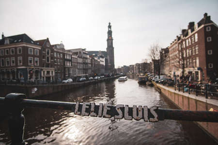 A wide shot of the city and the Westerkerk church with a river in Amsterdam Netherlandsの写真素材