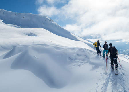 CHAMONIX, FRANCE - Feb 20, 2018: Three skiers skiing in a snowy mountainsのeditorial素材