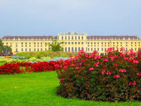 VIENNA, AUSTRIA - Oct 06, 2015: A wide angle shot of a building surrounded by trees, grass and flowersのeditorial素材
