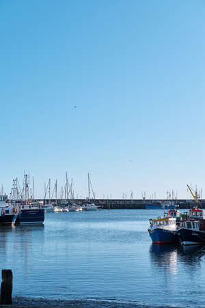 SCARBOROUGH, UNITED KINGDOM - Jan 18, 2020: Vertical shot of boats in Scarborough harbour in North...