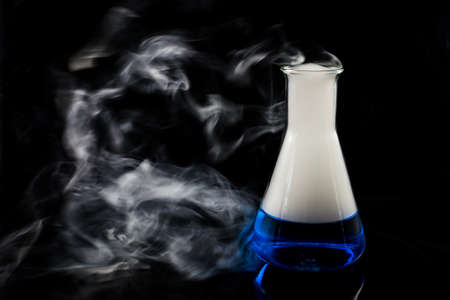 glas with a blue liquid used for chemical analysisの写真素材