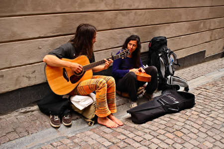 STOCKHOLM, SWEDEN - May 06, 2019: Two backpackers busking for money on the streets of Stockholm, Sweden.のeditorial素材