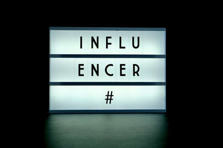 A display device with the word influencer and a hashtag sign