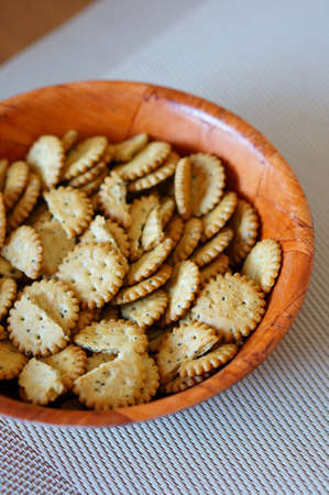 A vertical shot of a bowl of circular cookies on the table