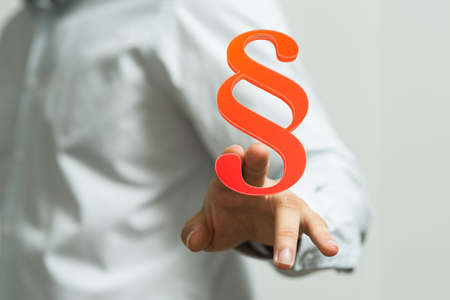 A person showing a virtual projection of a digital paragraph law symbolの写真素材