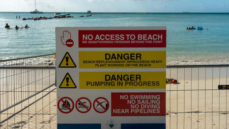A poster on the beach showing directions in Aruba