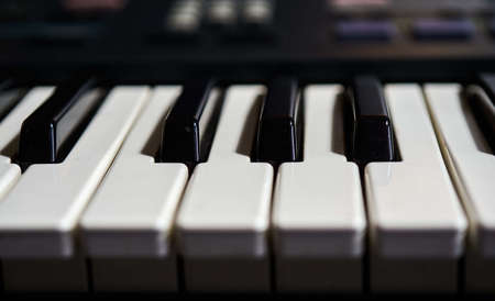 The black and white tiles of a piano during daytime